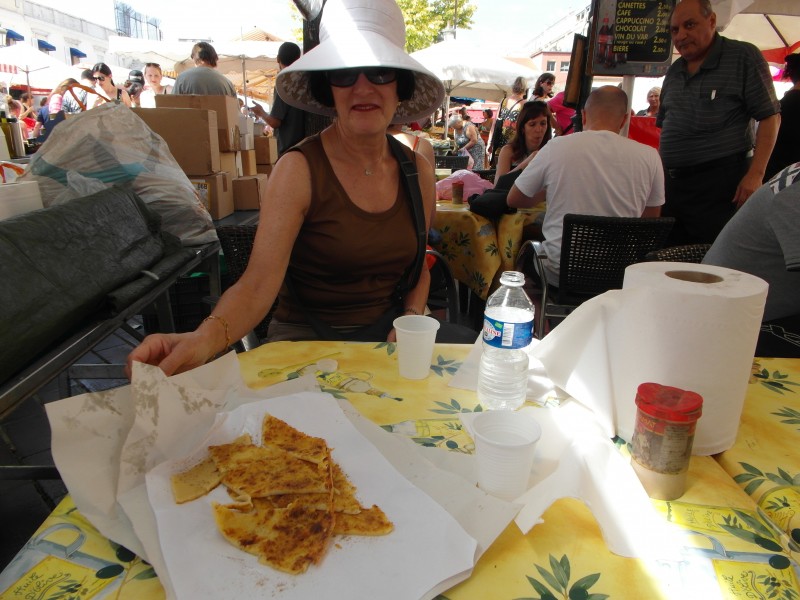 Enjoying socca at the Marche aux Fleurs (Flower Market) in Cours Saleya, Nice.
