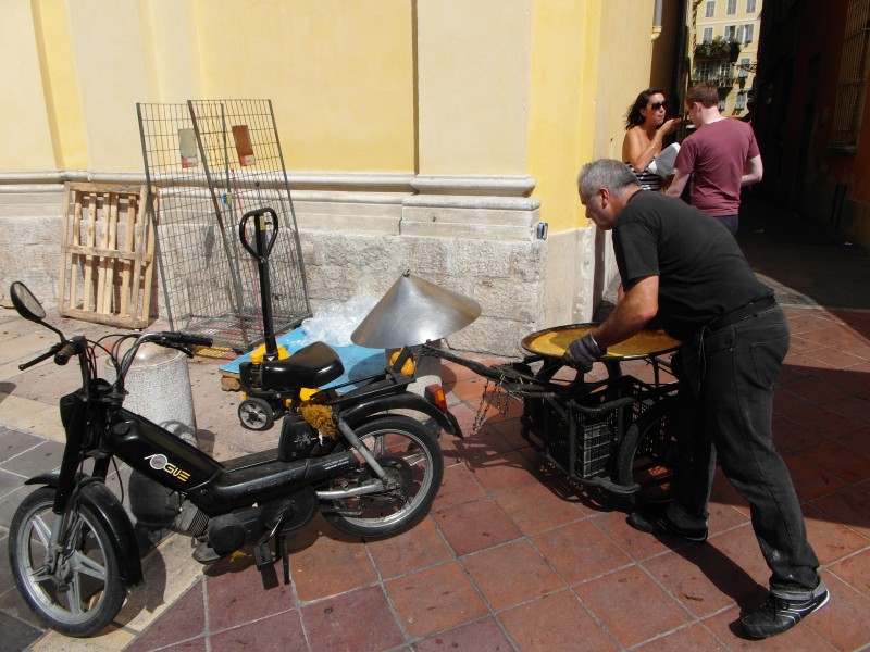 The socca is delivered by motorbike every few minutes to the food stand at the Flower Market on Cours Saleya in Nice